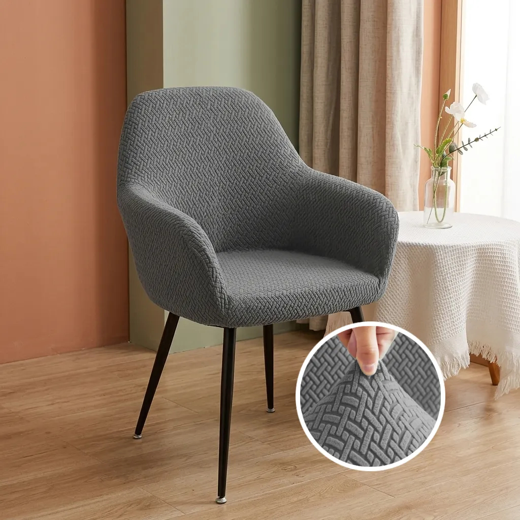 Front design of ash grey stretchable dining chair cover with integrated arm protection.